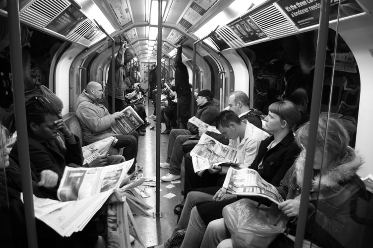 people-on-train-reading-papers.jpg